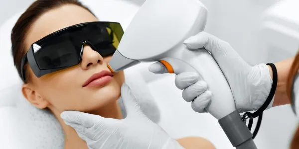 48892722 - face care. facial laser hair removal. beautician giving laser epilation treatment to young woman’s face at beauty clinic. body care. hairless smooth and soft skin. health and beauty concept.